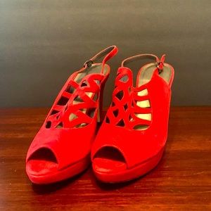 Red heels, never worn- injured knee before had chance to wear
